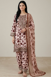 Woman wearing a floral traditional outfit with a plain background