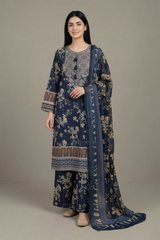 Woman wearing a traditional blue and patterned outfit with a matching dupatta against a neutral background