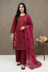 Woman wearing a red embroidered traditional outfit with a matching dupatta, standing against a plain background.