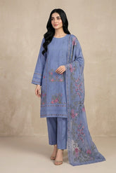 Woman wearing a blue embroidered outfit with a matching dupatta against a beige background