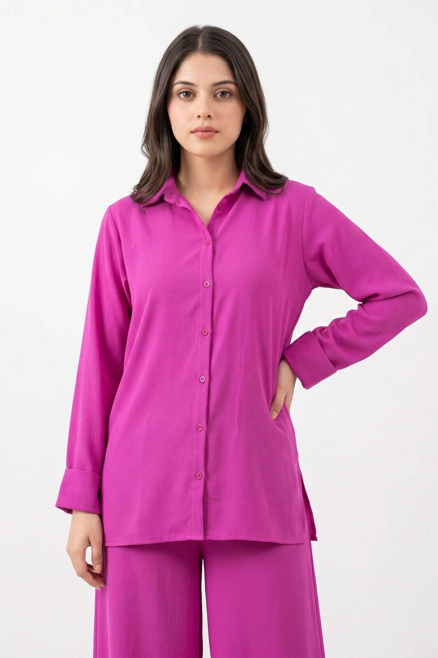 Woman wearing a pink pajama set on a white background