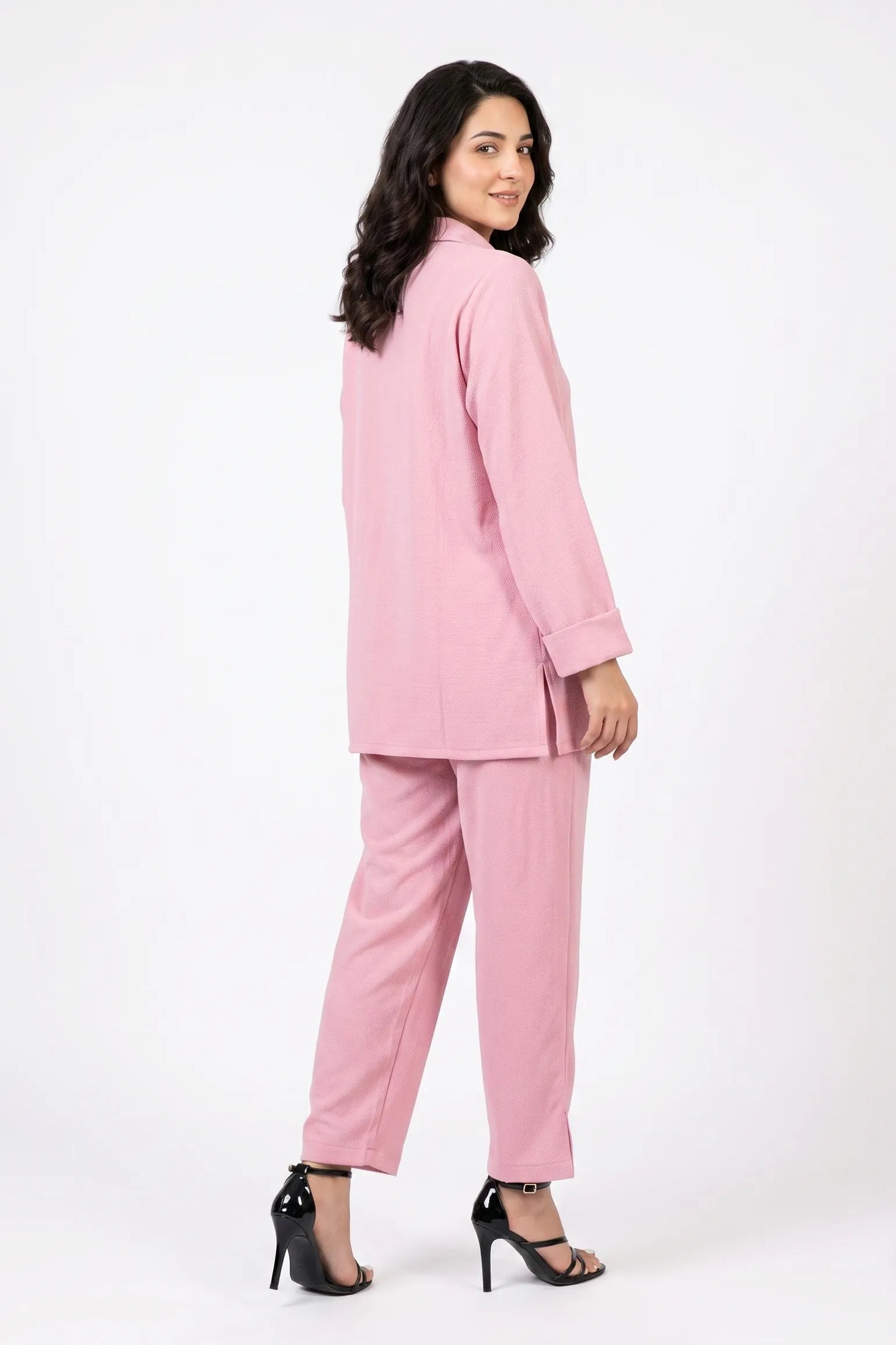 Woman wearing a pink suit on a white background