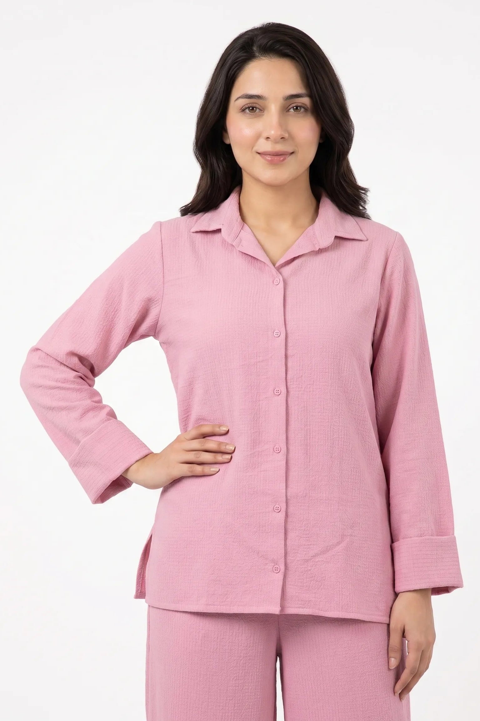 Woman wearing a pink pajama set on a white background