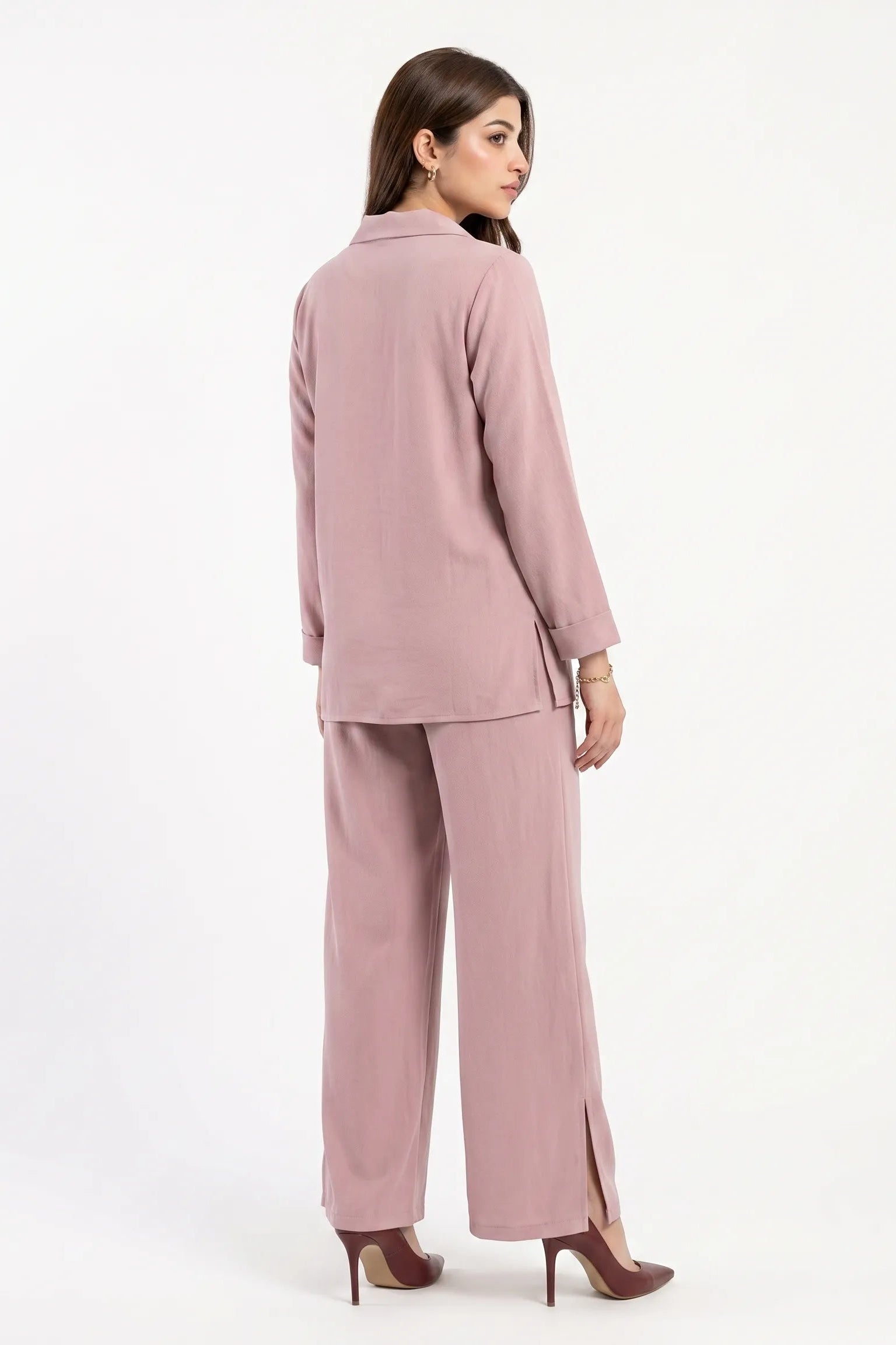 Woman wearing a pink suit on a white background