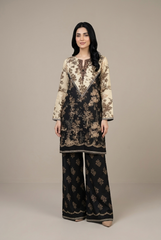 Woman wearing a black and beige floral embroidered outfit on a plain background