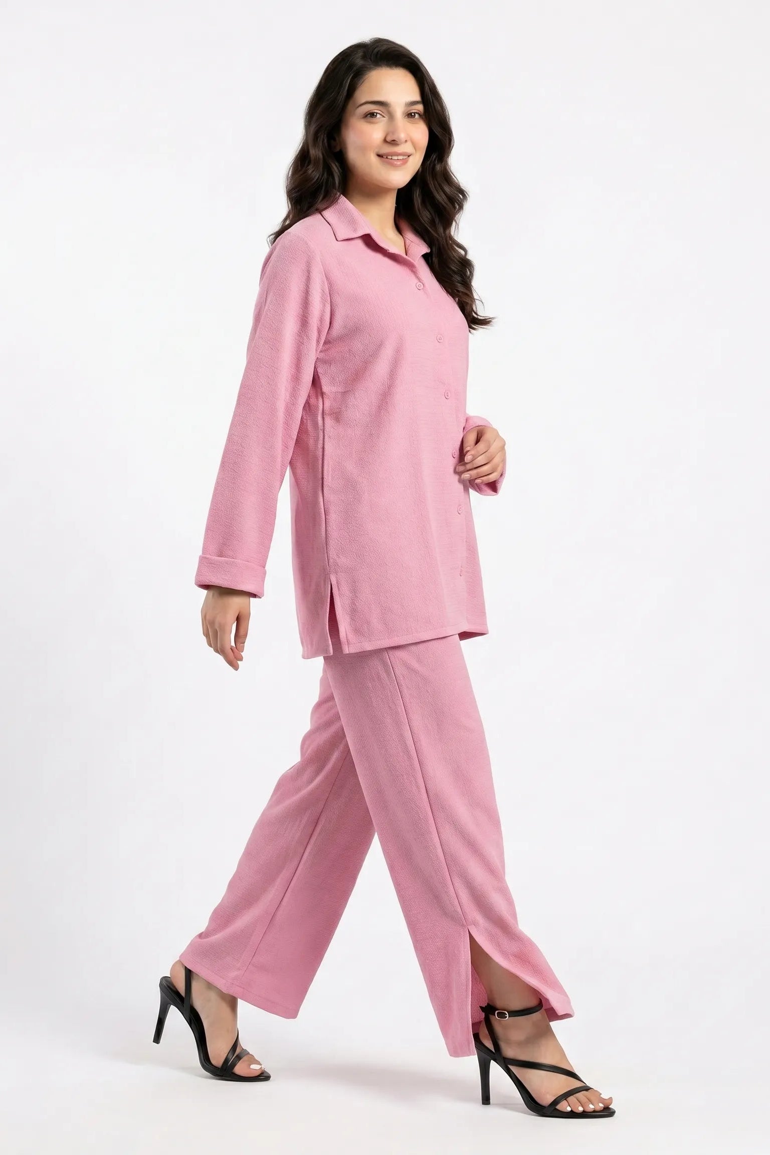 Woman wearing a pink suit on a white background