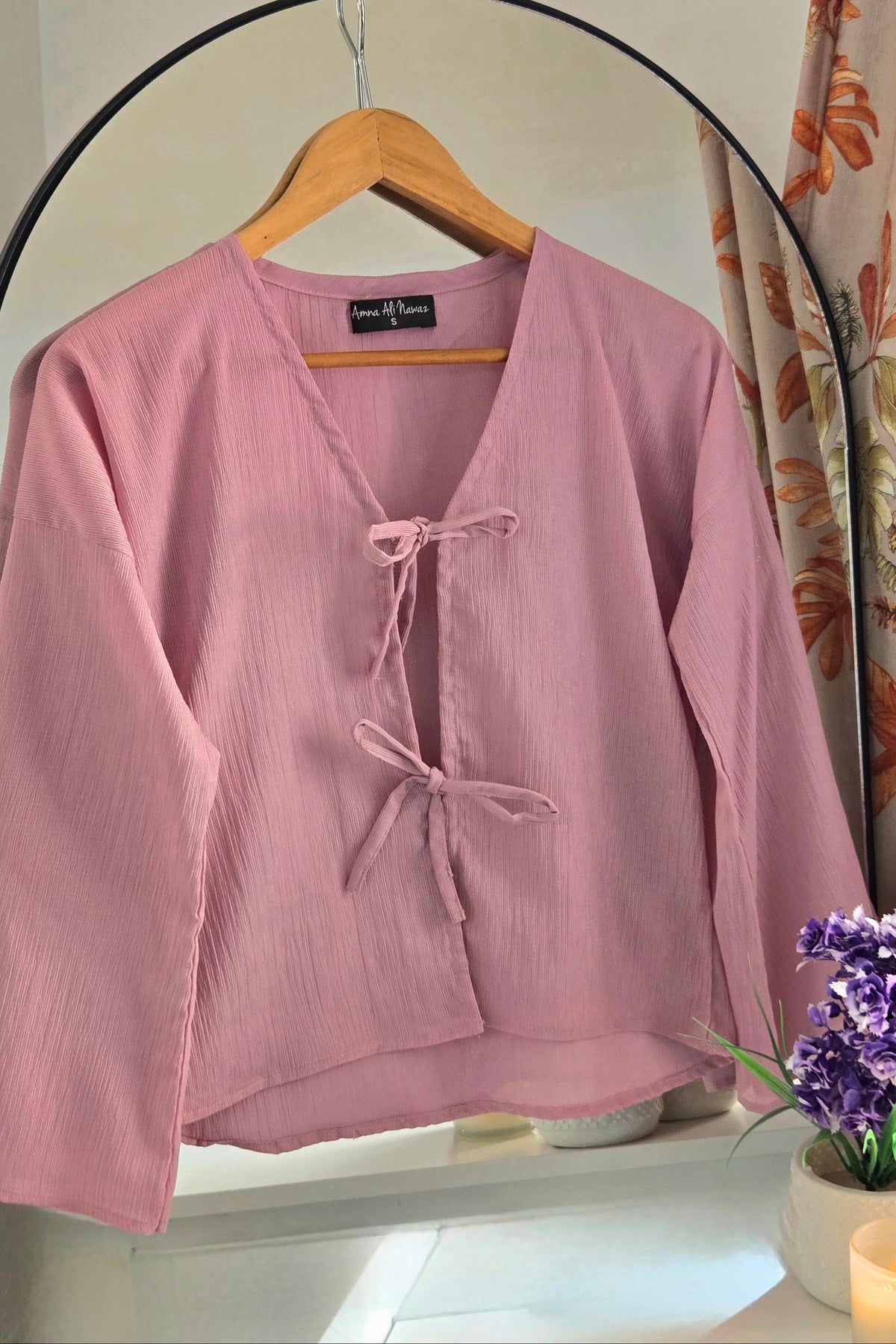 Pink bow blouse styled with white wide-leg trousers, Amna Ali Nawaz