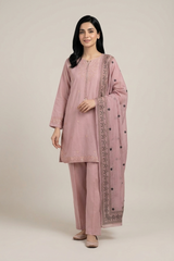 Woman wearing a pink traditional outfit with a matching dupatta on a beige background