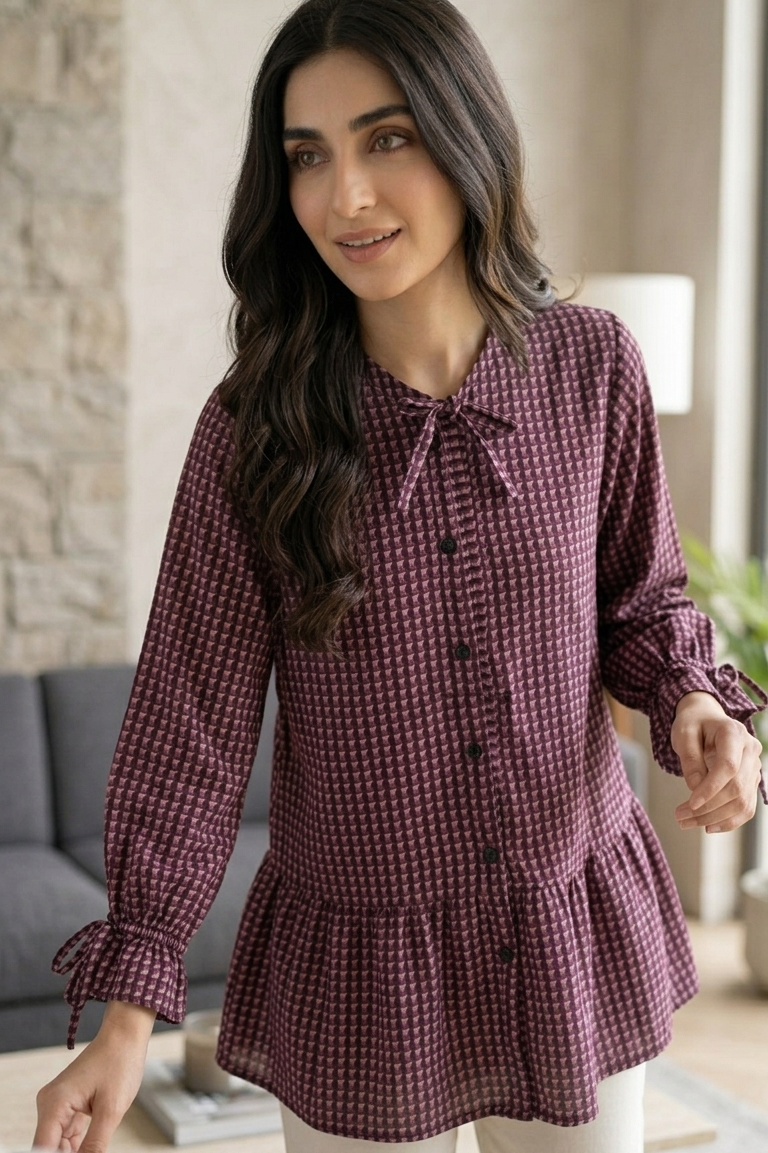 Woman wearing a purple checkered blouse in a living room setting