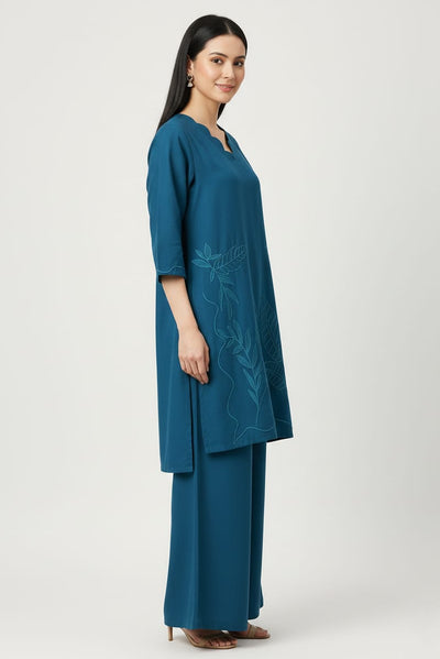 Woman wearing a Zinc color outfit with embroidered design on a white background