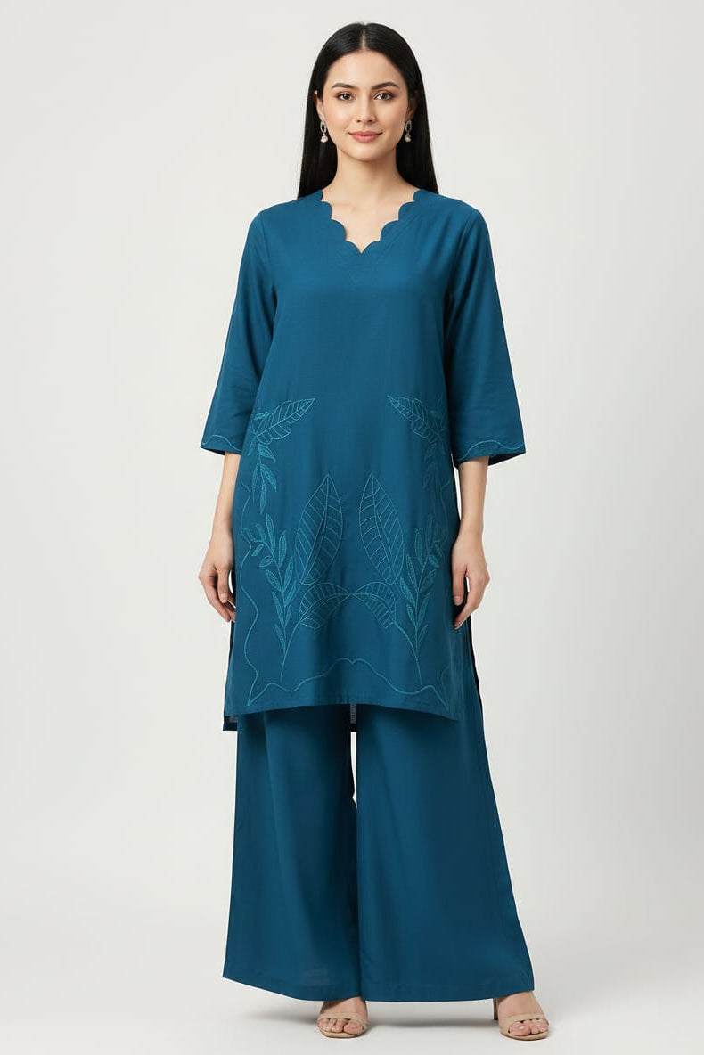 Woman wearing a Zinc color outfit with embroidered design on a white background