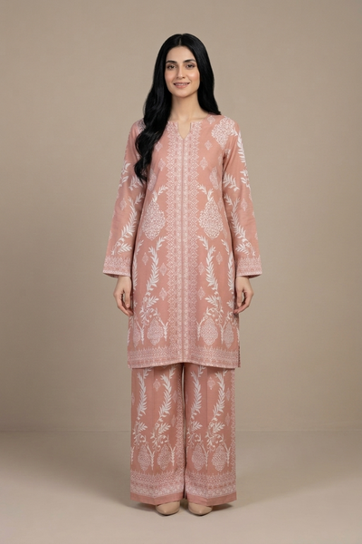 Woman wearing a pink embroidered traditional outfit against a beige background