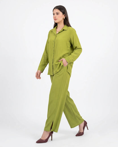 Woman wearing a green outfit on a white background