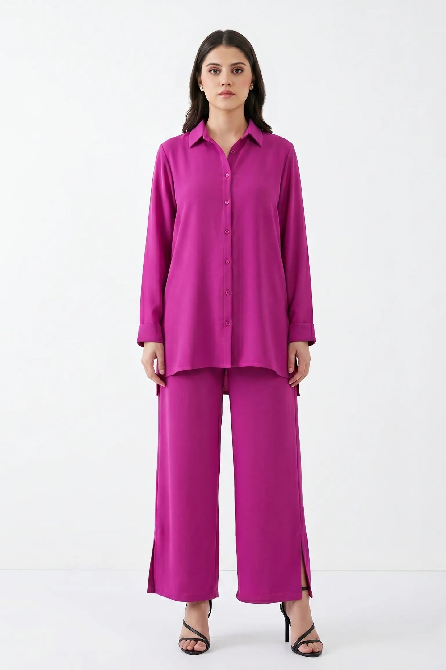Woman wearing a bright pink outfit on a white background