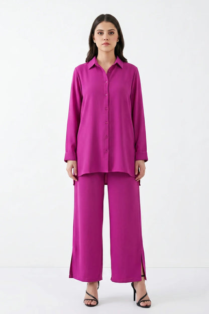 Woman wearing a bright pink outfit on a white background