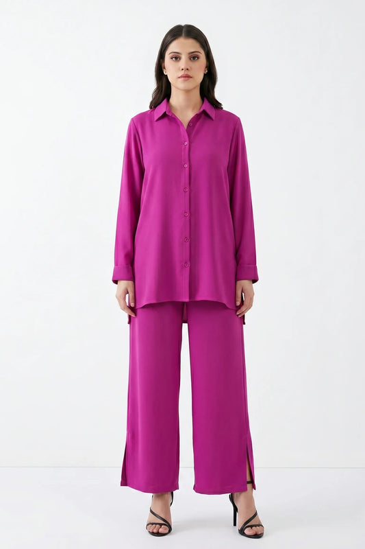 Woman wearing a bright pink outfit on a white background