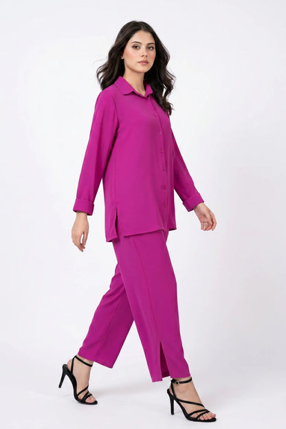 Woman wearing a bright pink suit on a white background