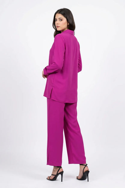 Woman wearing a bright pink suit on a white background