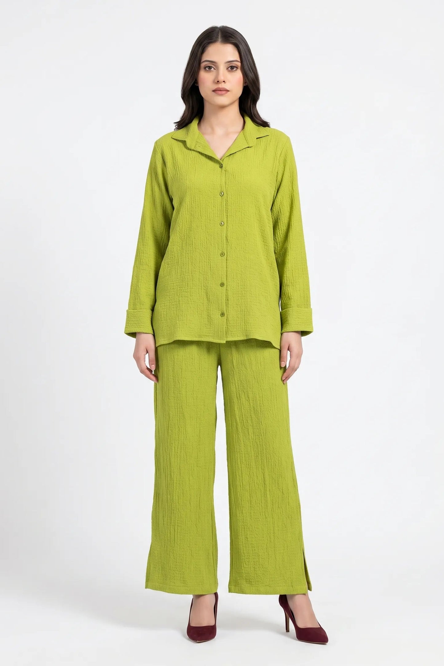 Woman wearing a green outfit on a white background