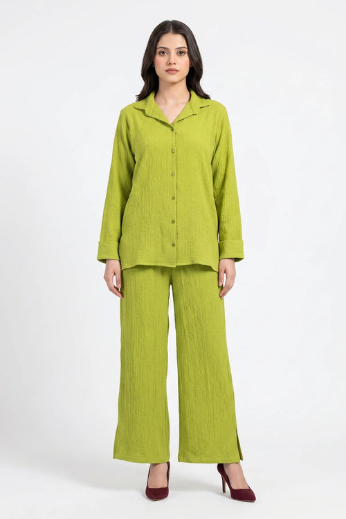 Woman wearing a green outfit on a white background
