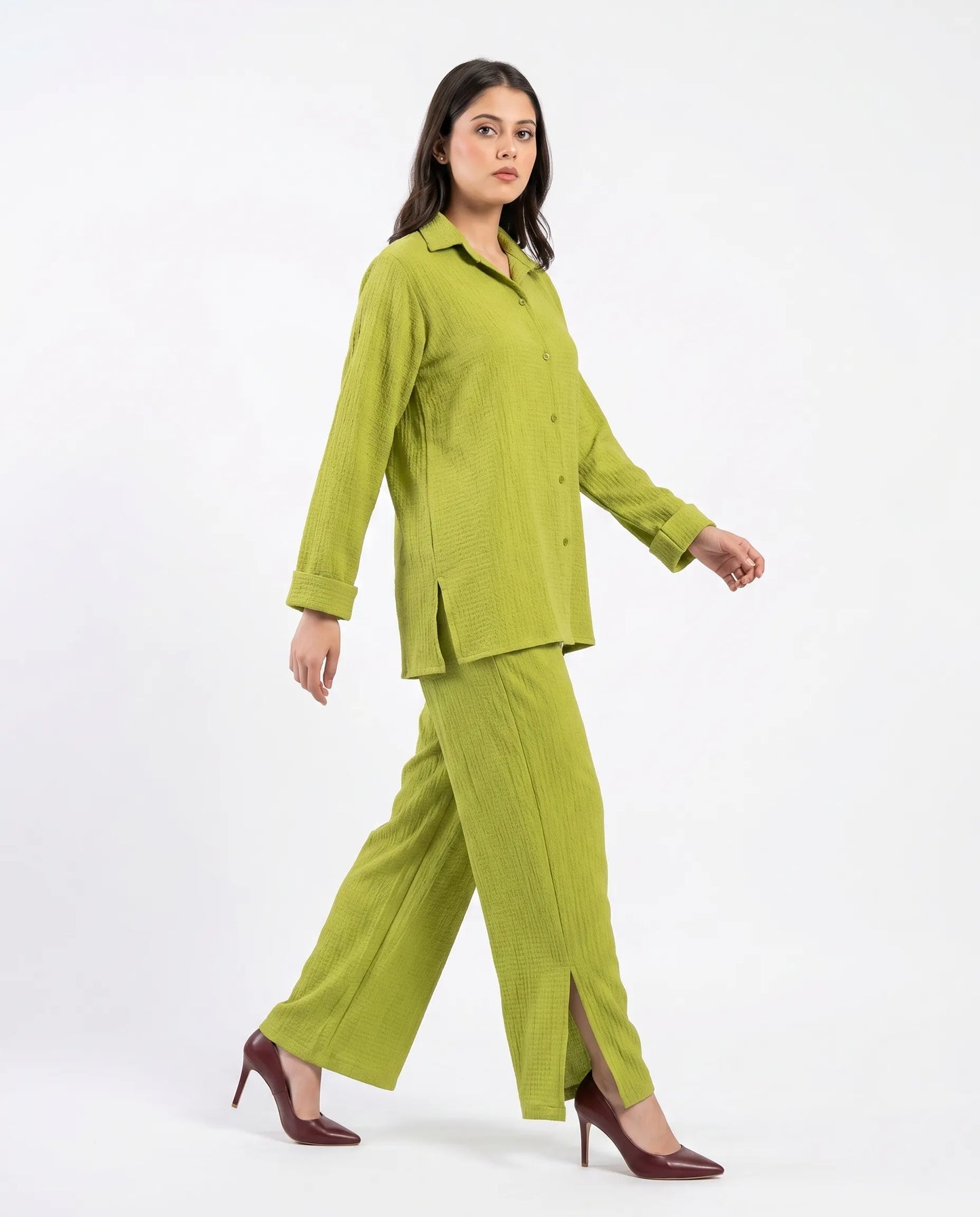 Woman wearing a green suit on a white background