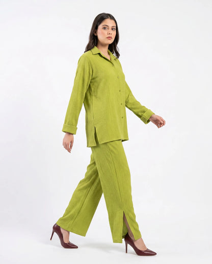 Woman wearing a green suit on a white background