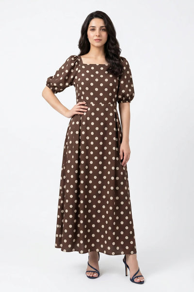 Woman wearing a brown polka dot dress on a white background