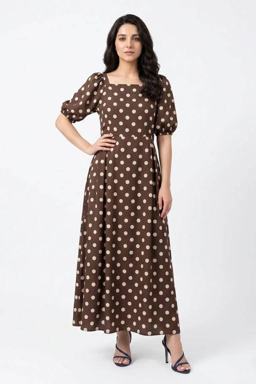 Woman wearing a brown polka dot dress on a white background