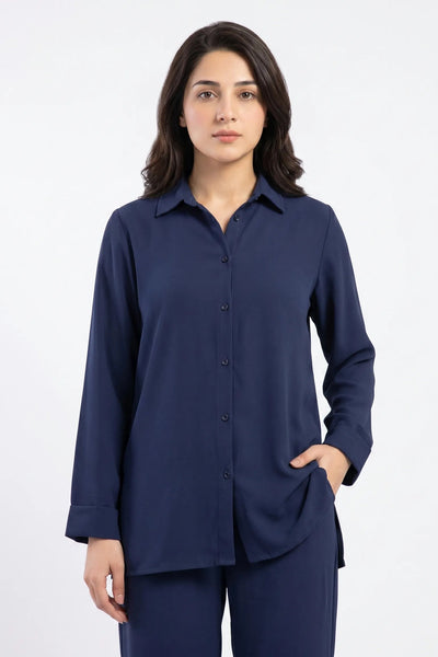 Woman wearing a navy blue shirt and pants on a white background