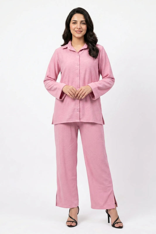 Woman wearing a pink pajama set on a white background