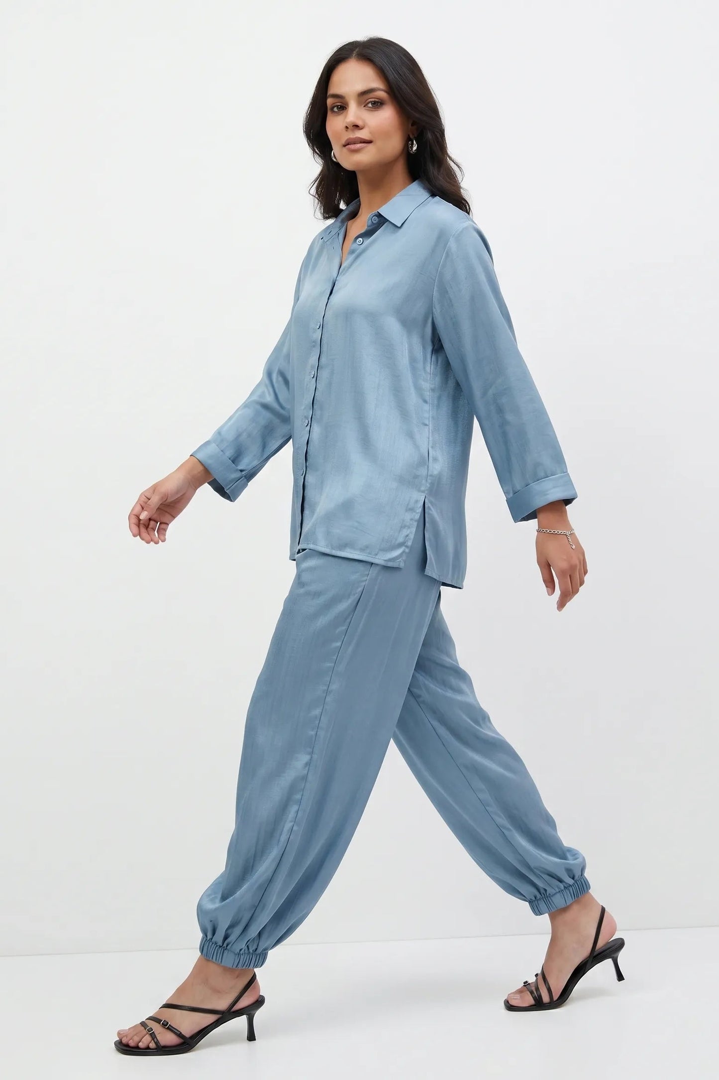 Woman wearing a light blue outfit on a white background