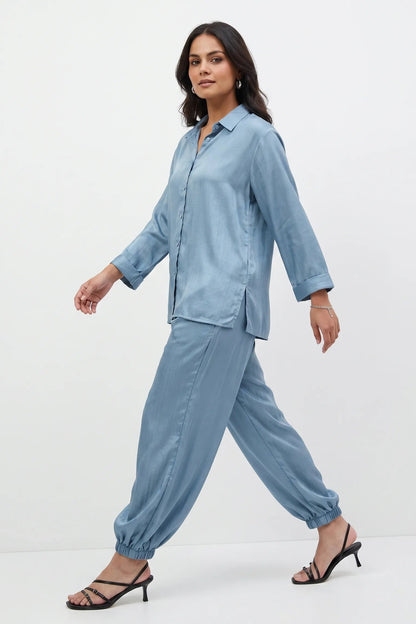 Woman wearing a light blue outfit on a white background