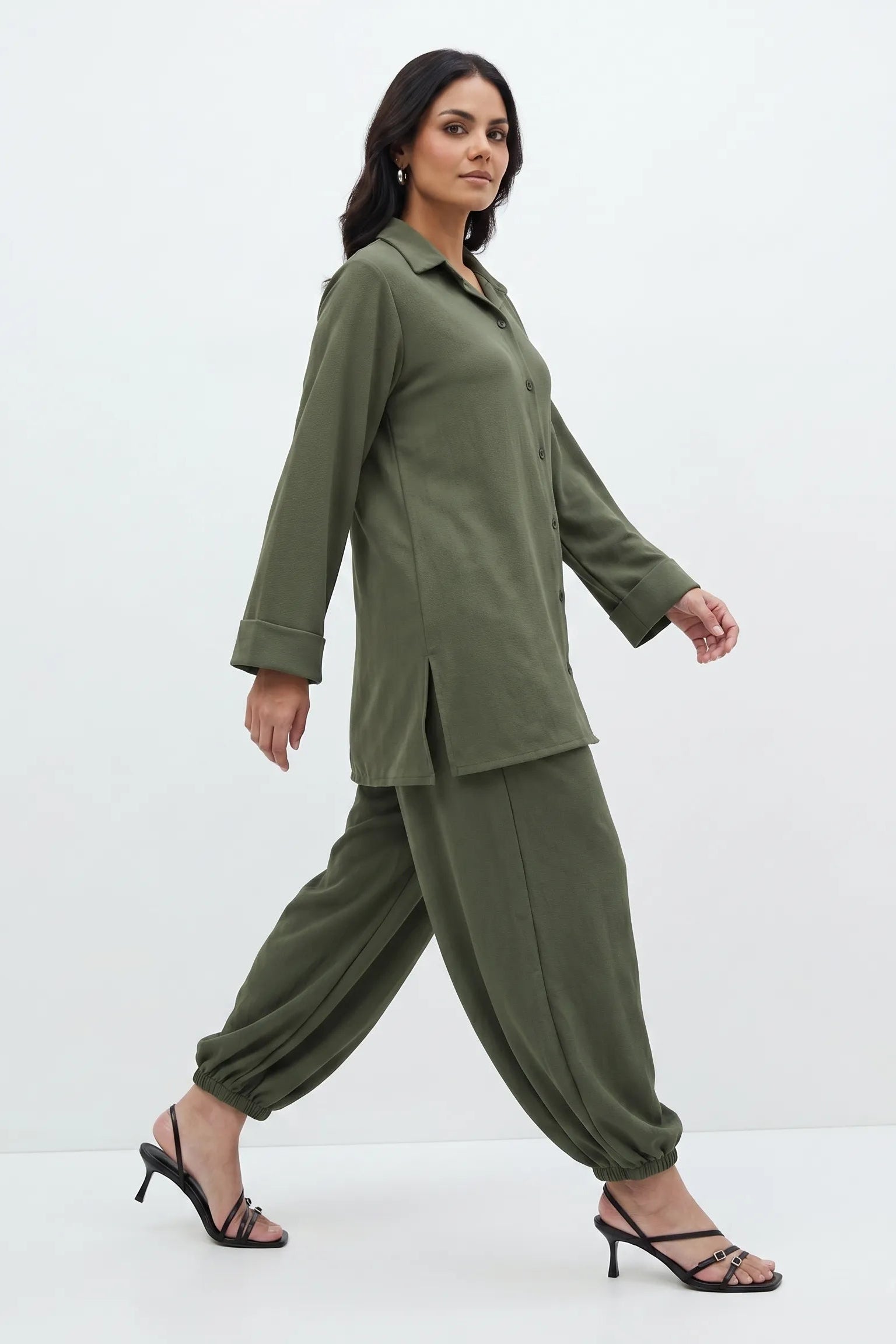 Woman wearing a green outfit on a white background