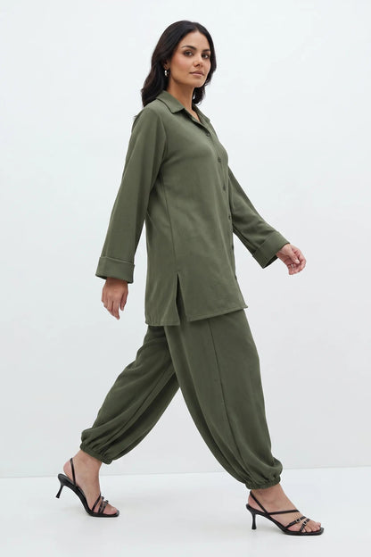 Woman wearing a green outfit on a white background