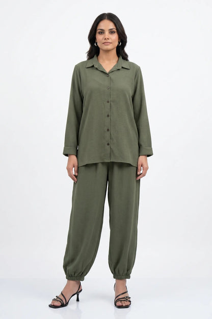 Woman wearing a green outfit on a white background