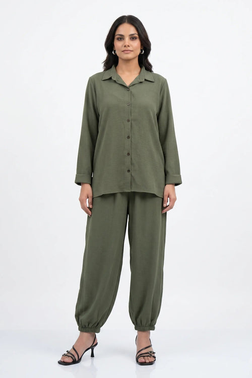 Woman wearing a green outfit on a white background