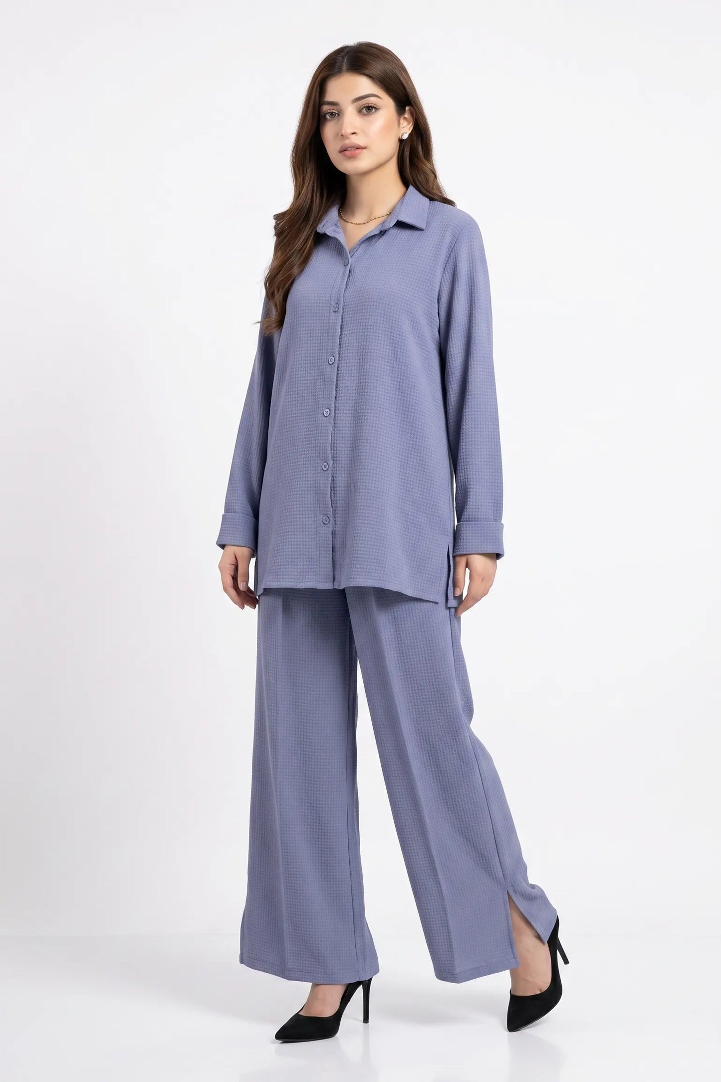 Woman wearing a light blue outfit on a white background
