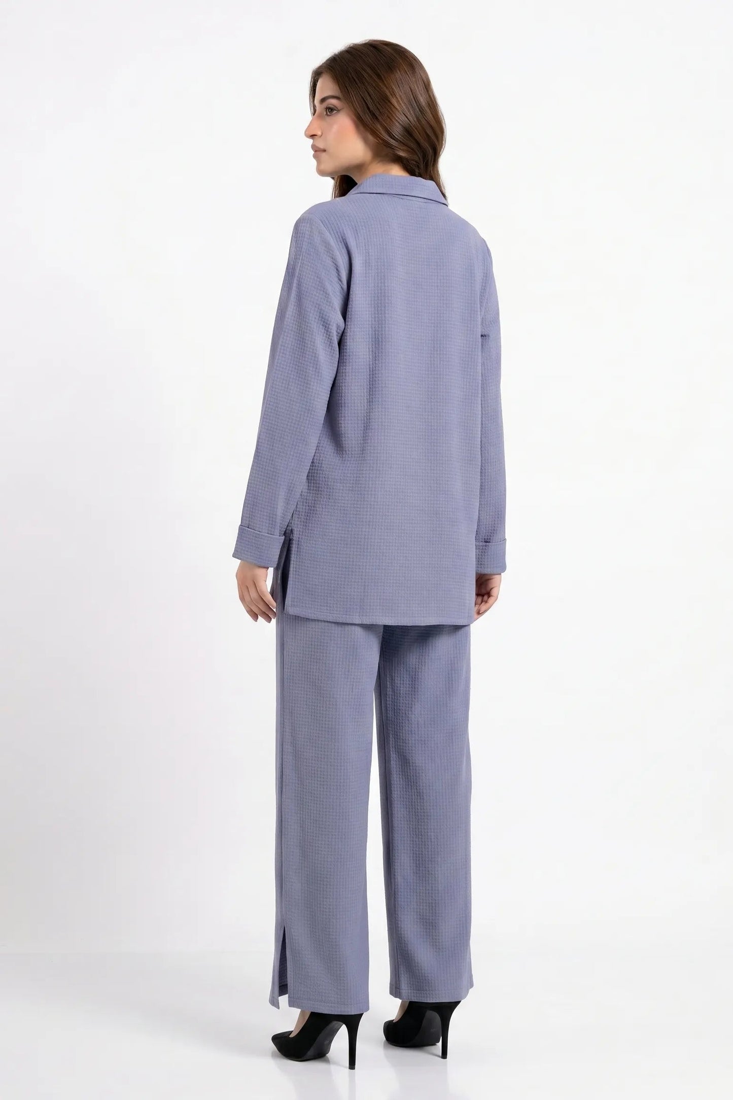 Woman wearing a light blue suit on a white background