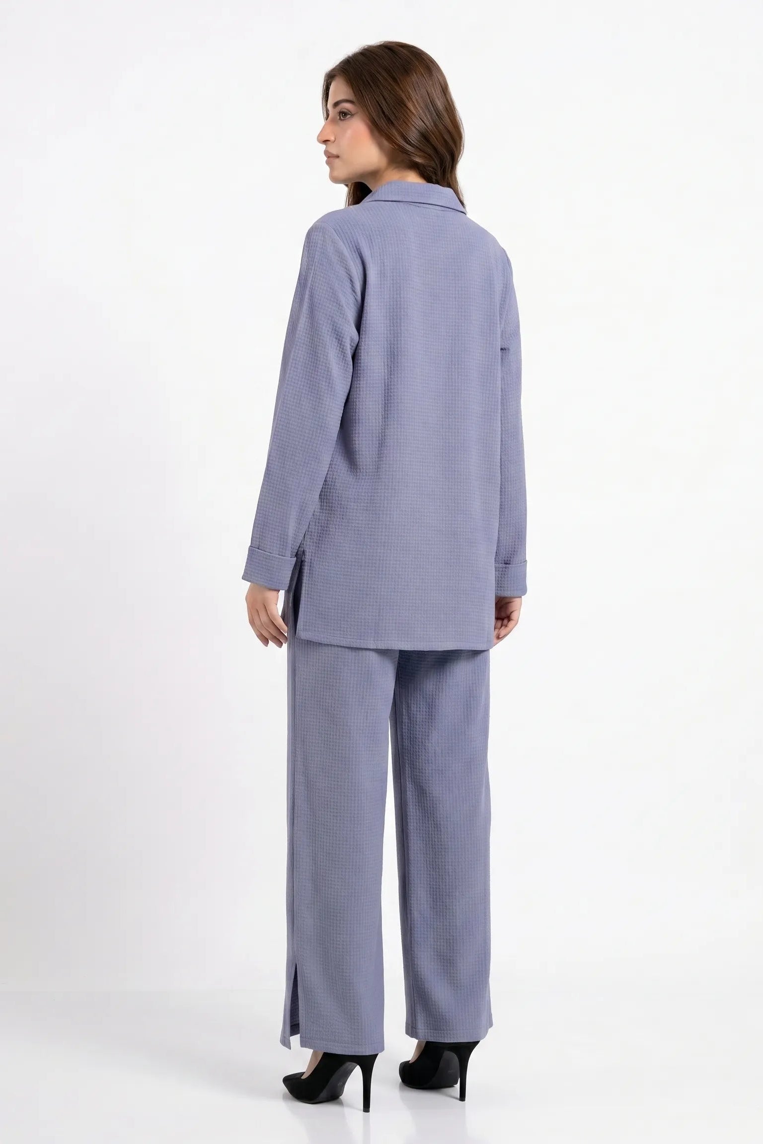 Woman wearing a light blue suit on a white background