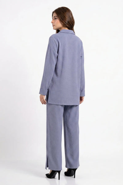 Woman wearing a light blue suit on a white background