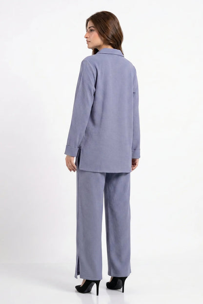 Woman wearing a light blue suit on a white background