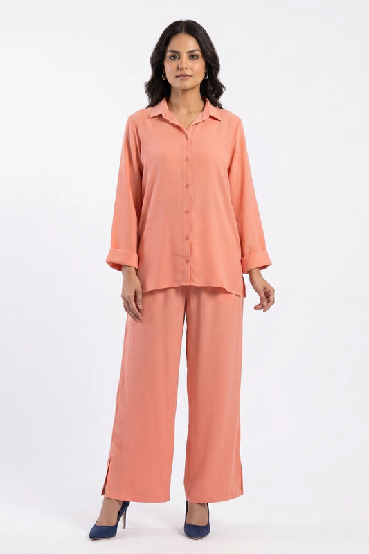 Woman wearing a peach pajama set on a white background