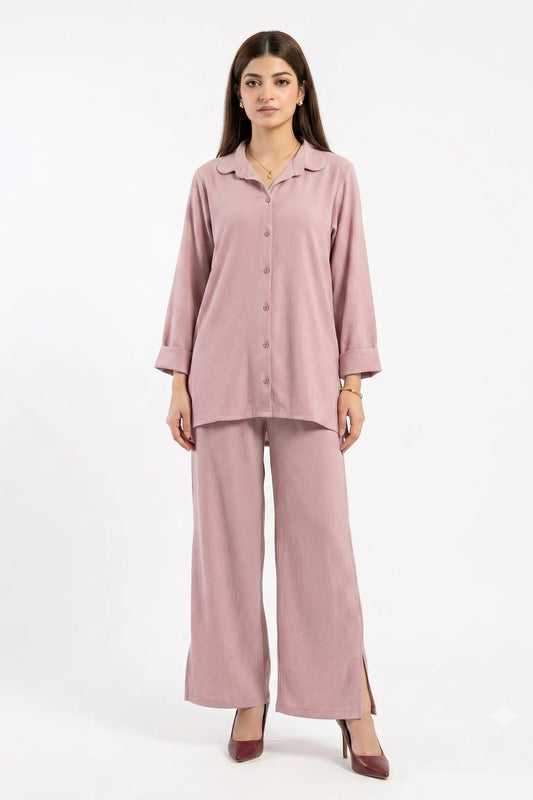 Woman wearing a pink pajama set on a white background