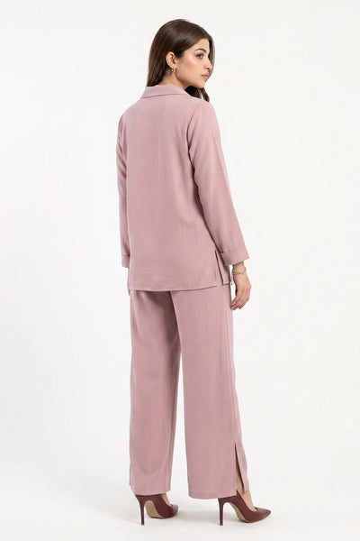 Woman wearing a pink suit on a white background