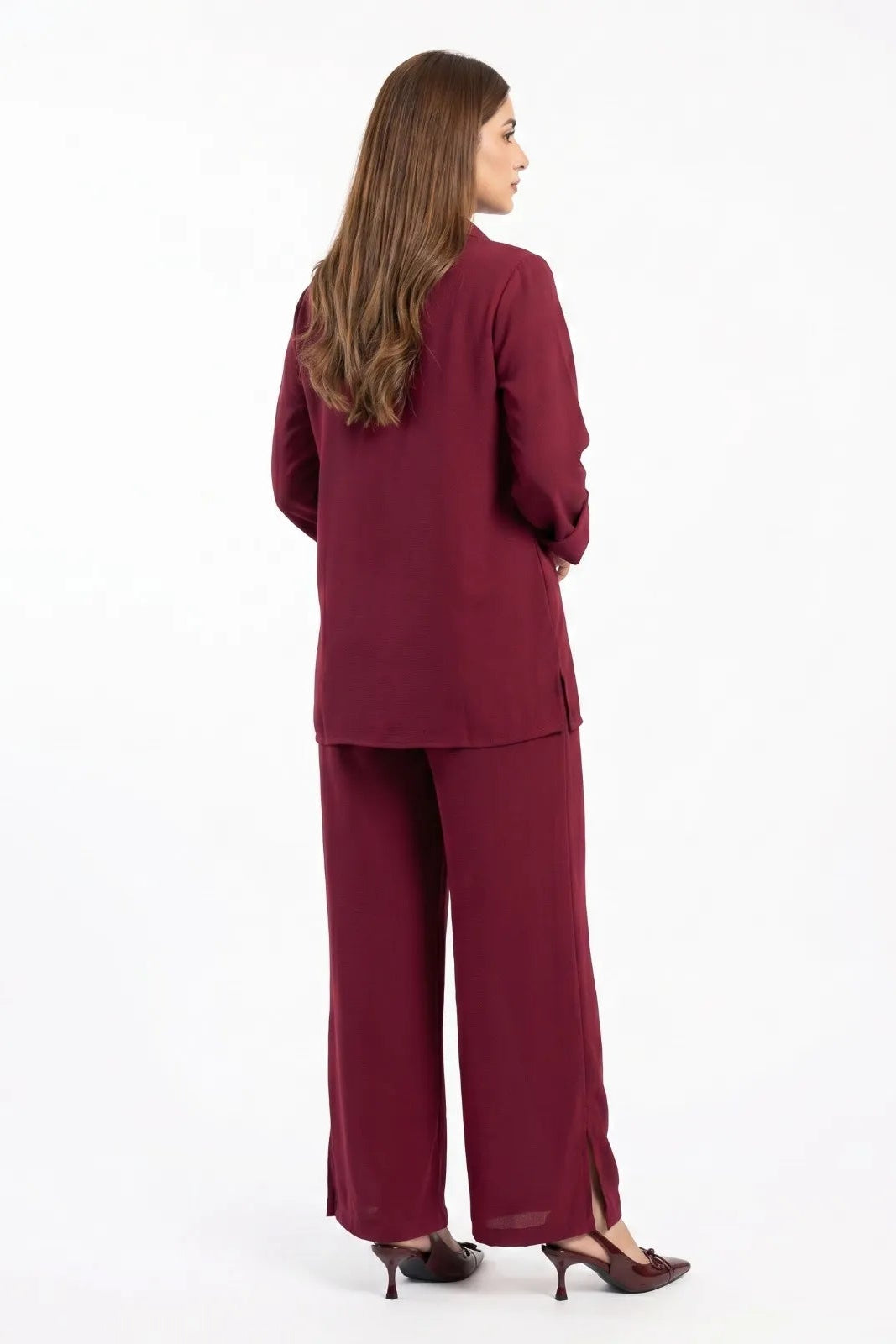 Woman wearing a burgundy suit on a white background