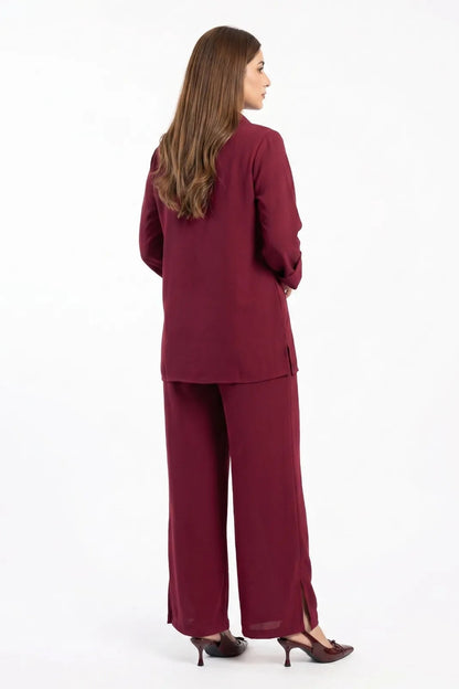 Woman wearing a burgundy suit on a white background