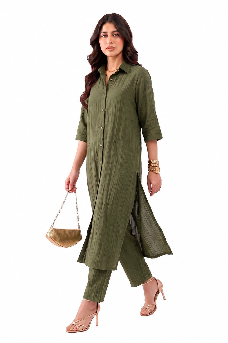 A woman modeling an olive green kurta set with matching pants, holding a small tan handbag against a plain white background.